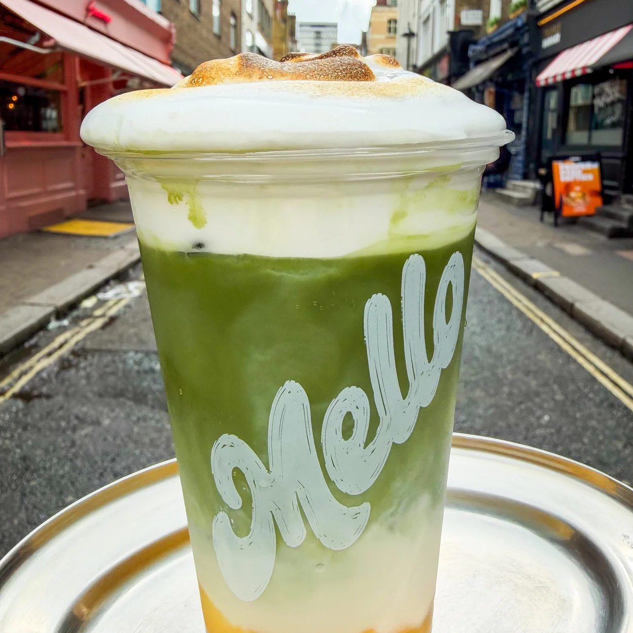 Layered matcha and mango drink from Mello Deluxe