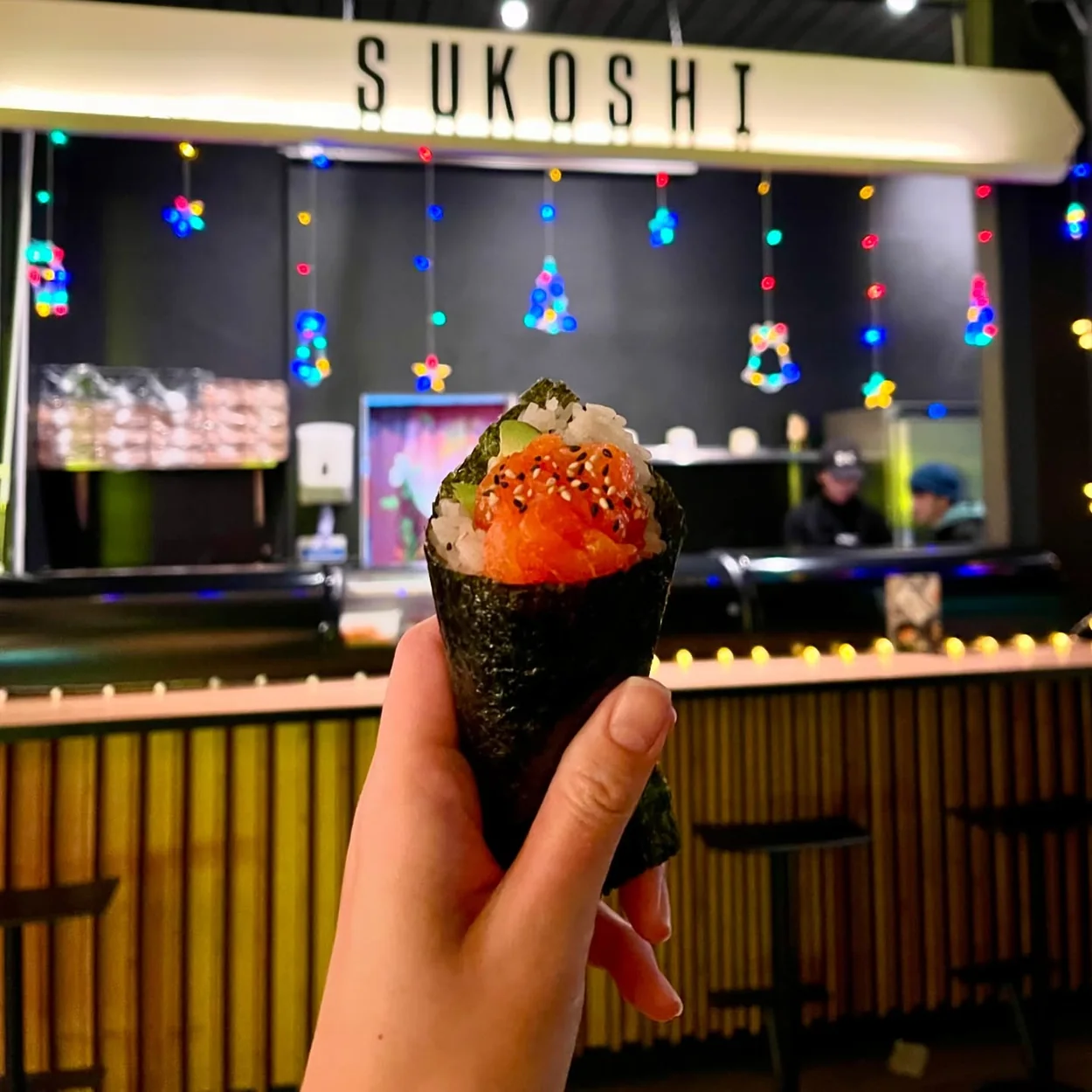 Hand roll held in front of the Sukoshi counter at Seven Dials Market