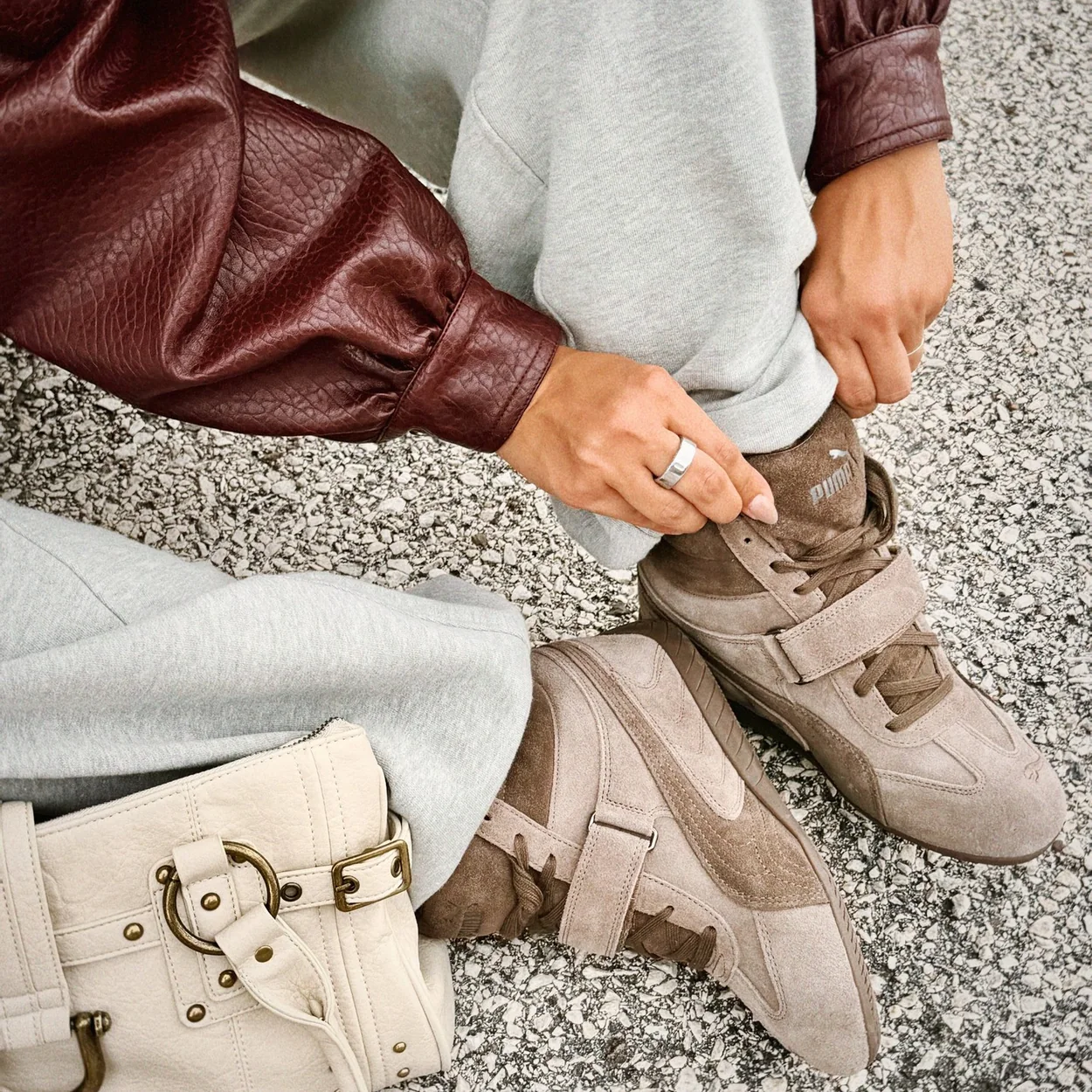 Urban Outfitters accessories styled with trainers, a bag and knitwear